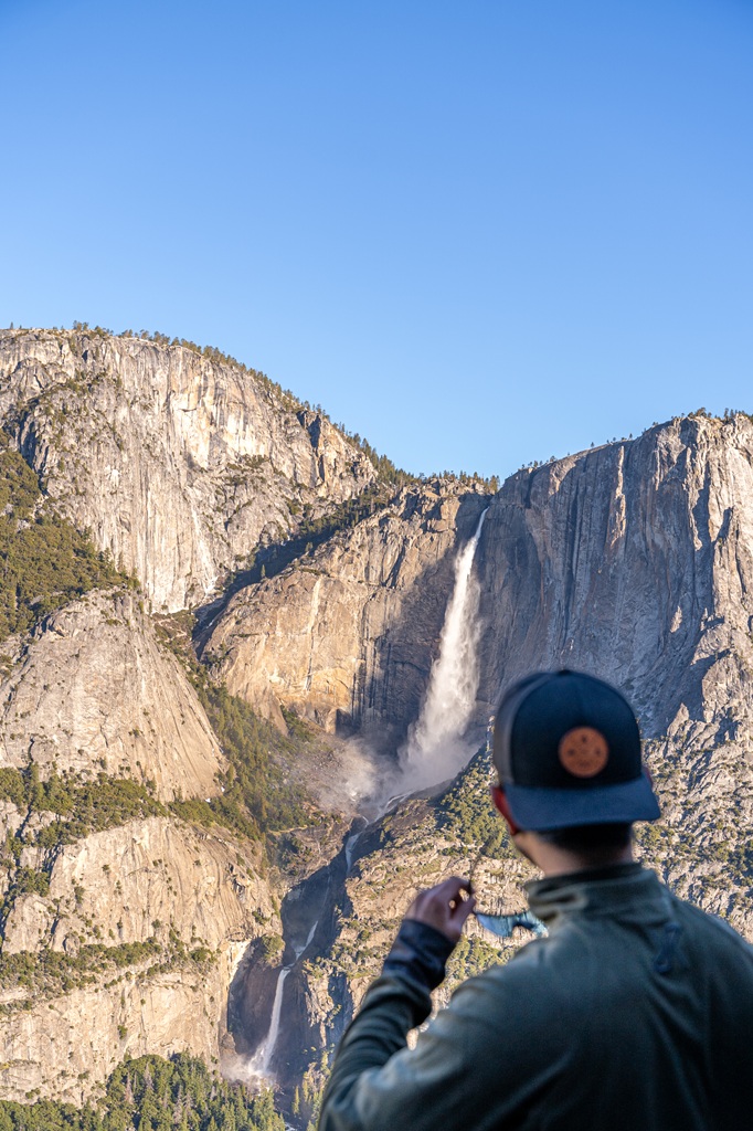 Man looking at Yosemite Falls from the Four Mile Trail in Yosemite National Park.