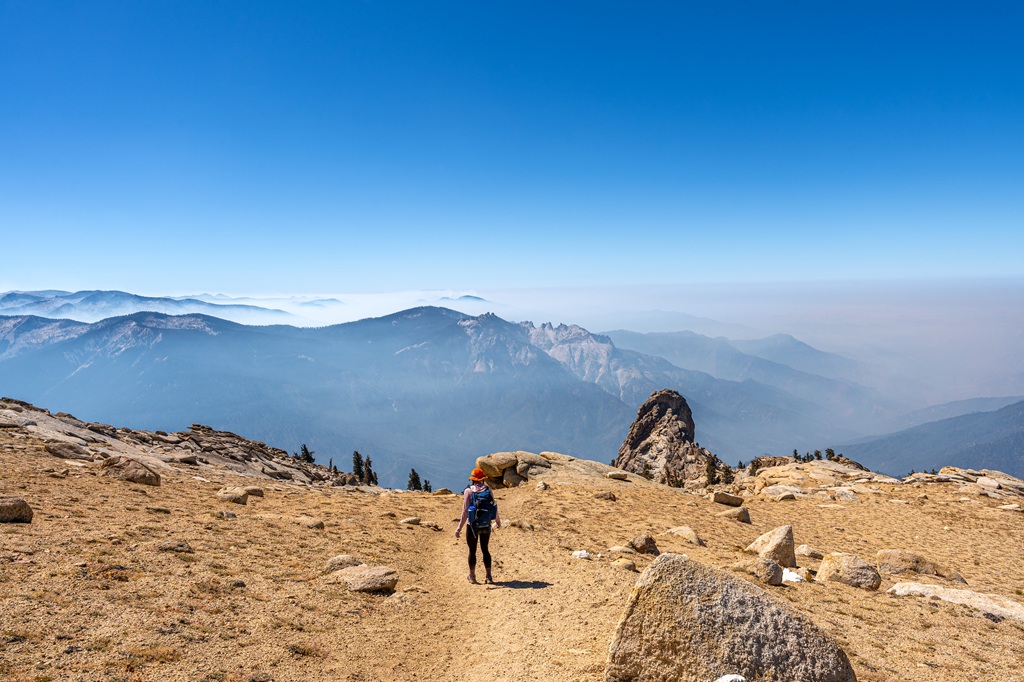 Woman hiking along the Alta Peak Trail in Sequoia with smoky conditions from the Coffee Pot Fire.