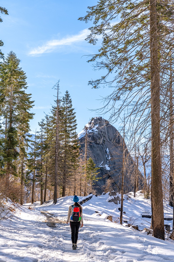 Woman walking towards Moro Rock in Sequoia National Park in winter.