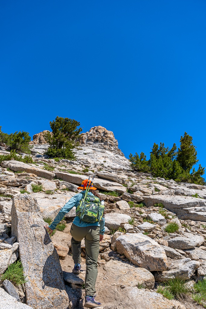 Woman scrambling along the Mount Hoffmann Trail in Yosemite National Park.