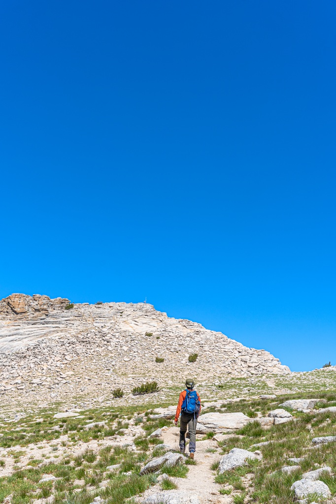 Man hiking towards the summit of Mount Hoffmann in Yosemite National Park.