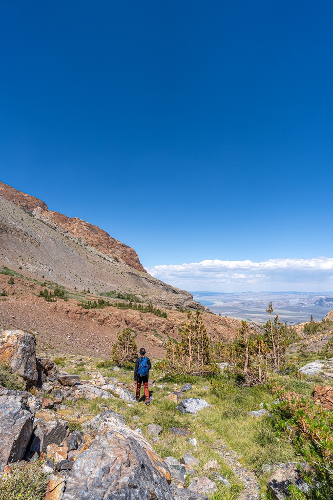 Man hiking along the Bloody Canyon Trail towards Upper and Lower Sardine Lakes.