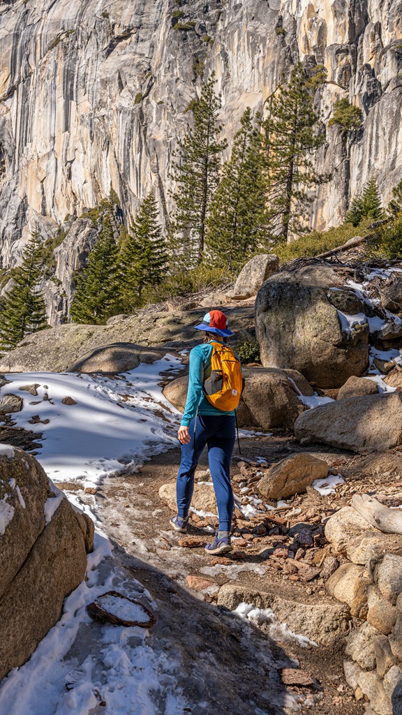 Woman hiking along the Upper Yosemite Fall Trail in winter.