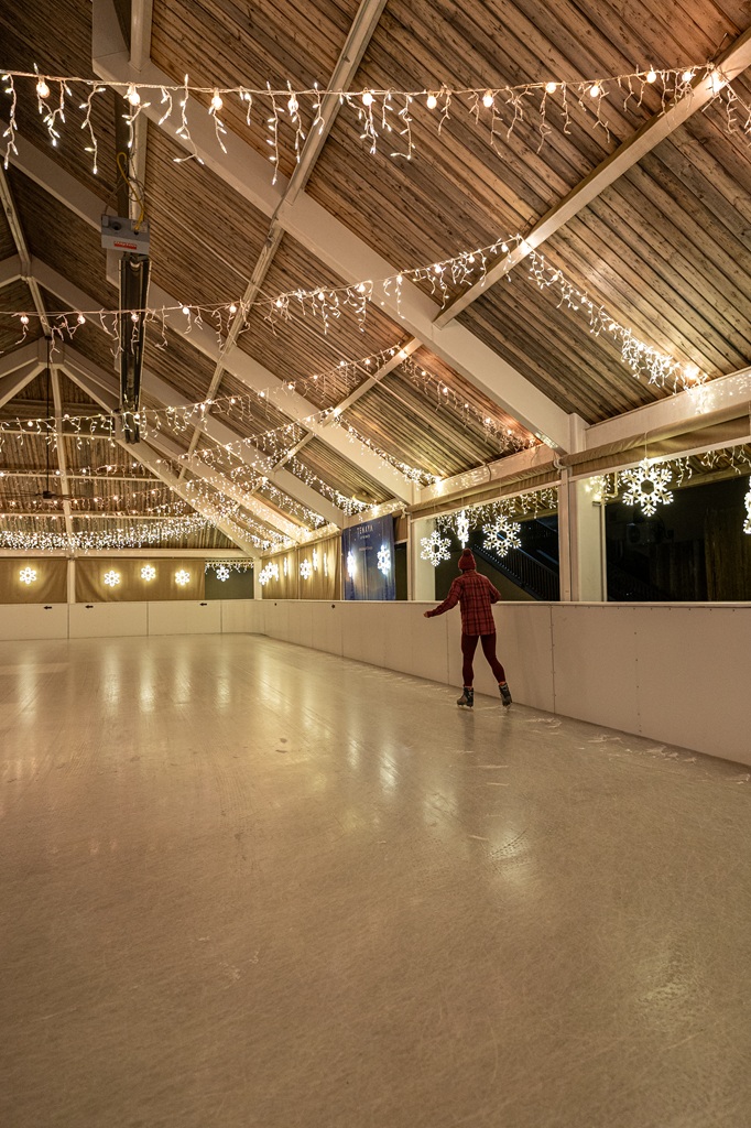 Woman ice skating at Tenaya Lodge in winter.