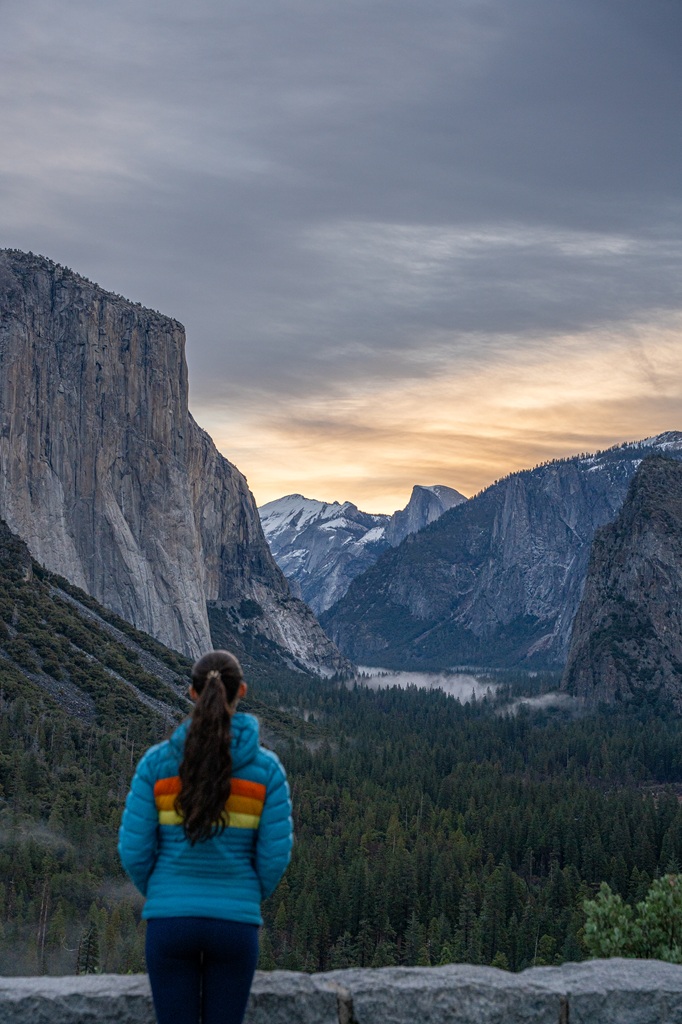 Woman watching the sunrise from Tunnel View in Yosemite.