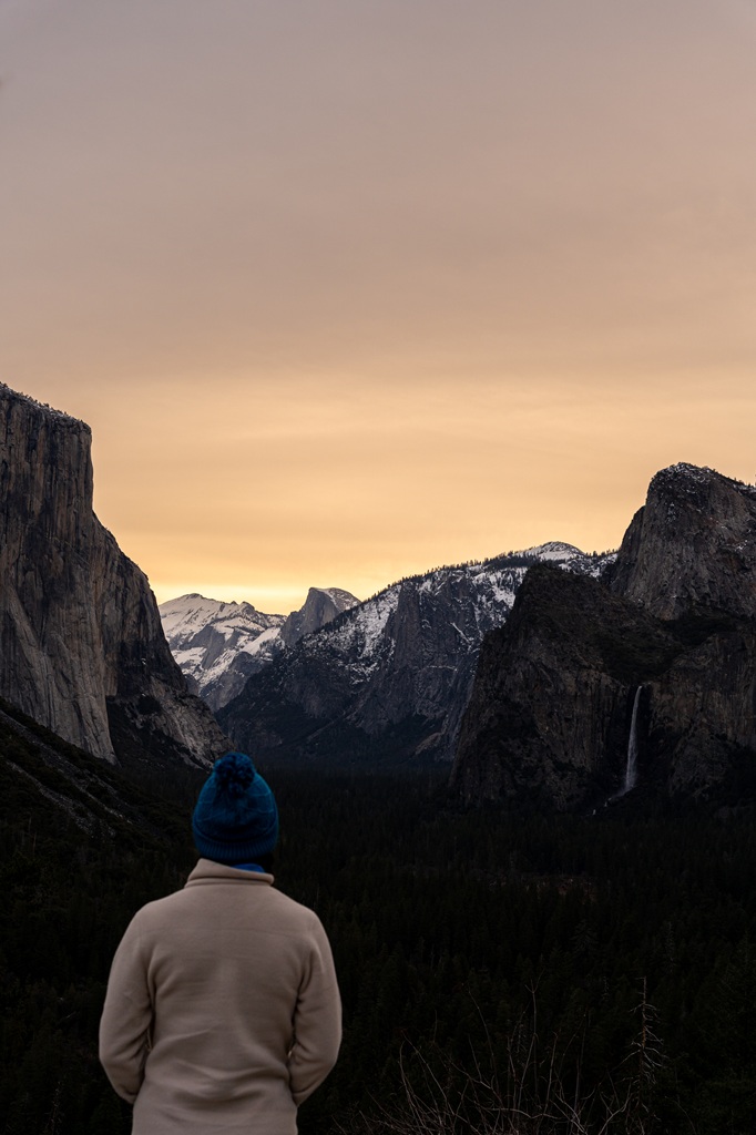 Woman watching the sunrise at Tunnel View in winter in Yosemite.