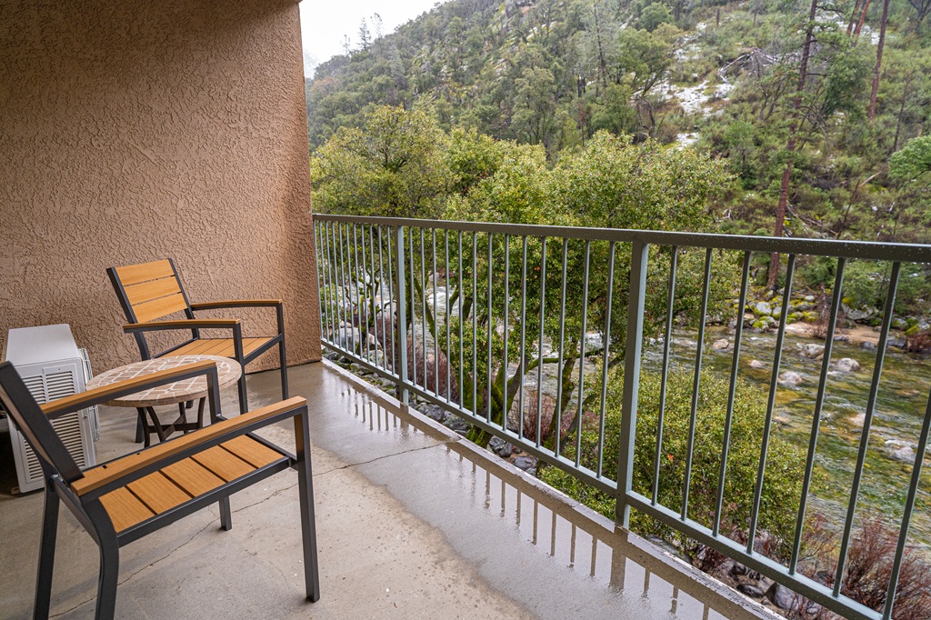 Room with a balcony and river view at Yosemite View Lodge.