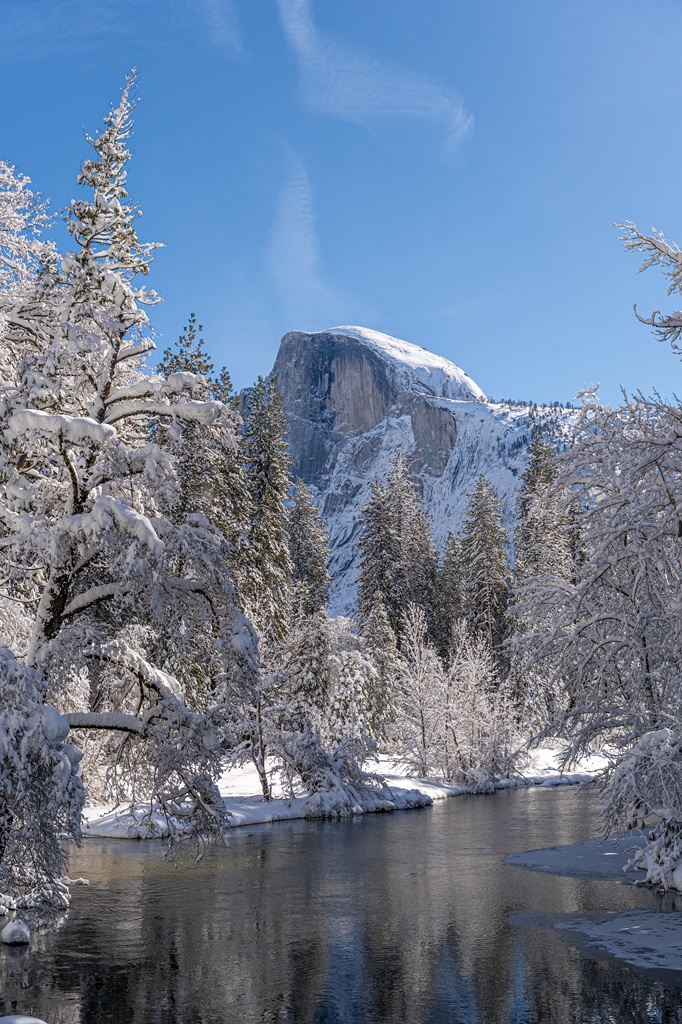 View of snow-covered Half Dome from Sentinel Bridge in Yosemite National Park.