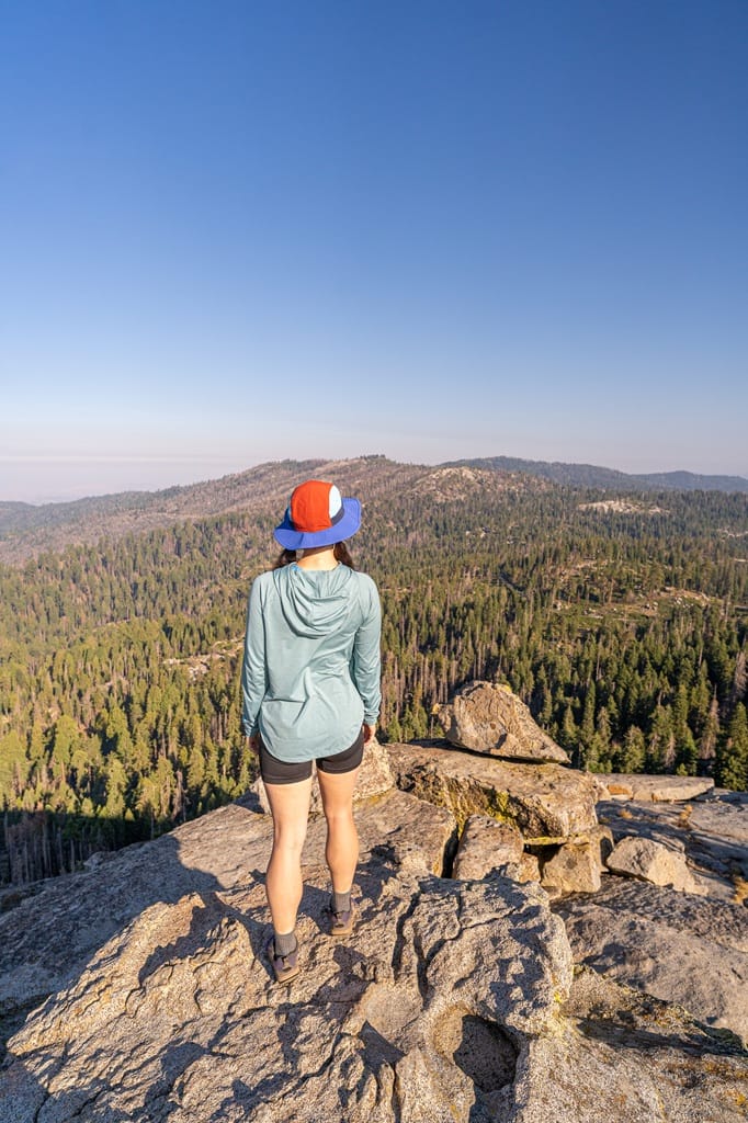 Woman standing on Buena Vista Peak looking at the views of Kings Canyon and Sequoia National Park.