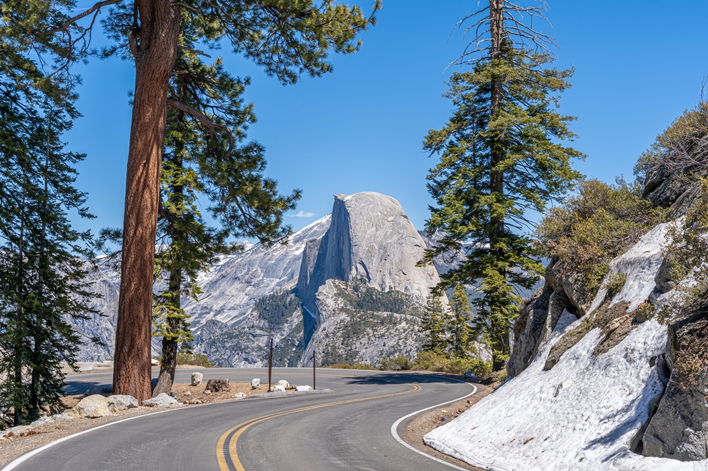 View of the famous curve along Glacier Point Road with scenic view of Half Dome.