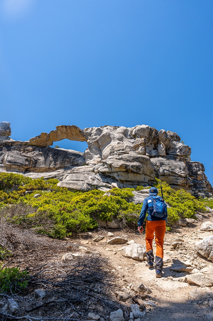 Man hiking towards Indian Arch in Yosemite National Park.