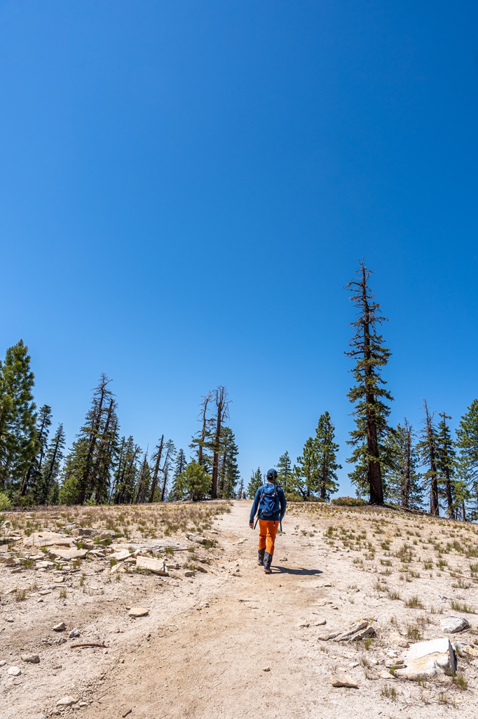 Man hiking along the North Dome Trail in Yosemite National Park.