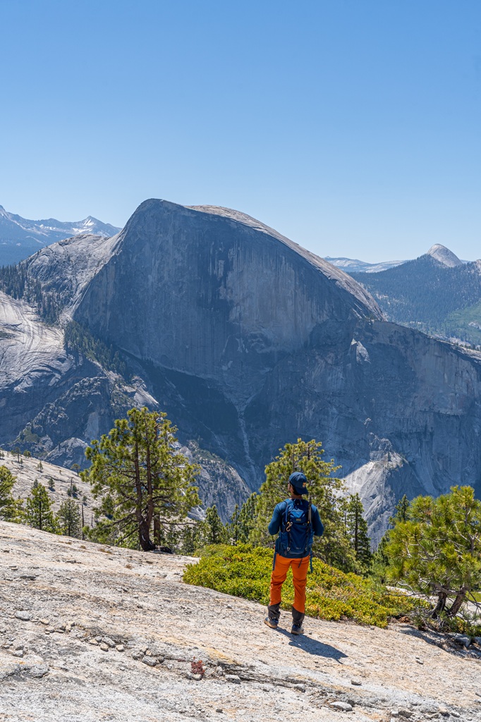 Man looking at Half Dome in the distance from Indian Ridge near North Dome.