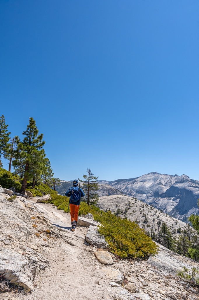 Man hiking along the North Dome Trail in Yosemite National Park.