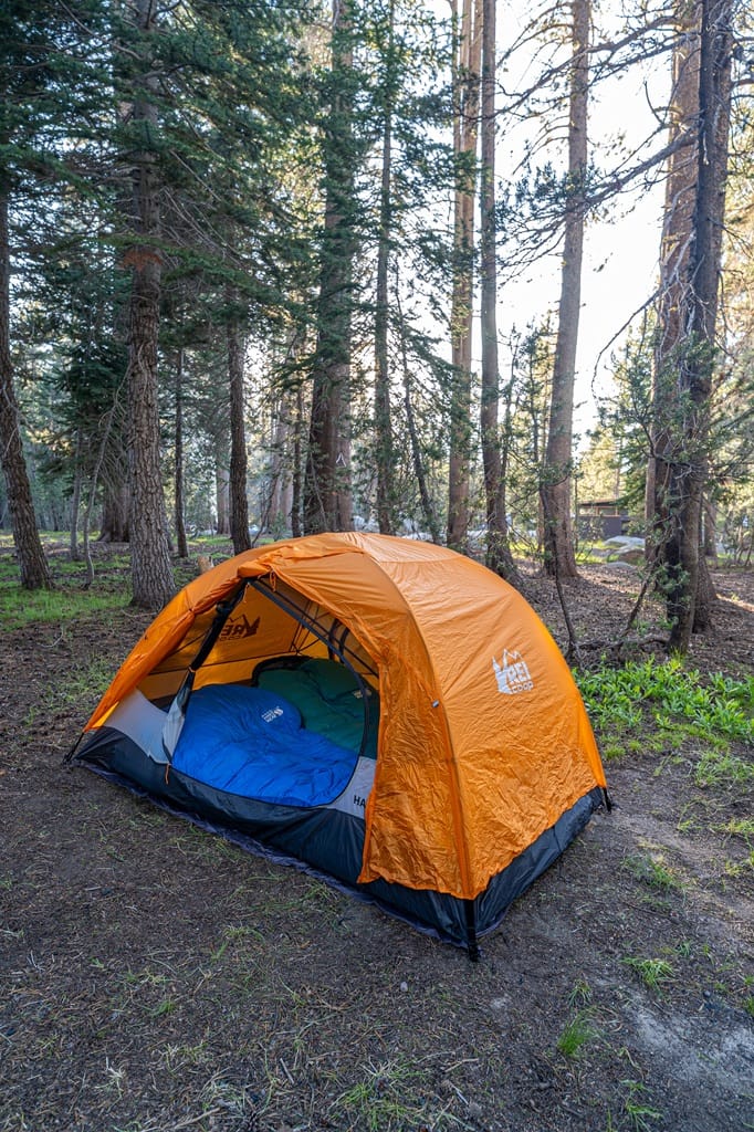 Orange tent open with sleeping bags inside at White Wolf Campground in Yosemite National Park.