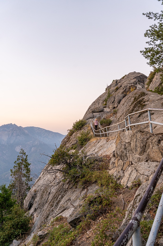 Woman climbing up the steps along the Moro Rock Trail in Sequoia National Park.