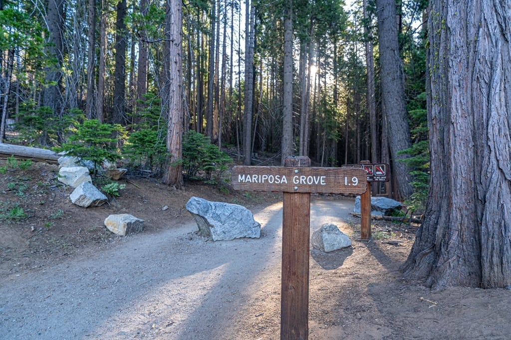 Trail sign indicating the distance to Mariposa Grove via the Washburn Trail in Yosemite National Park.