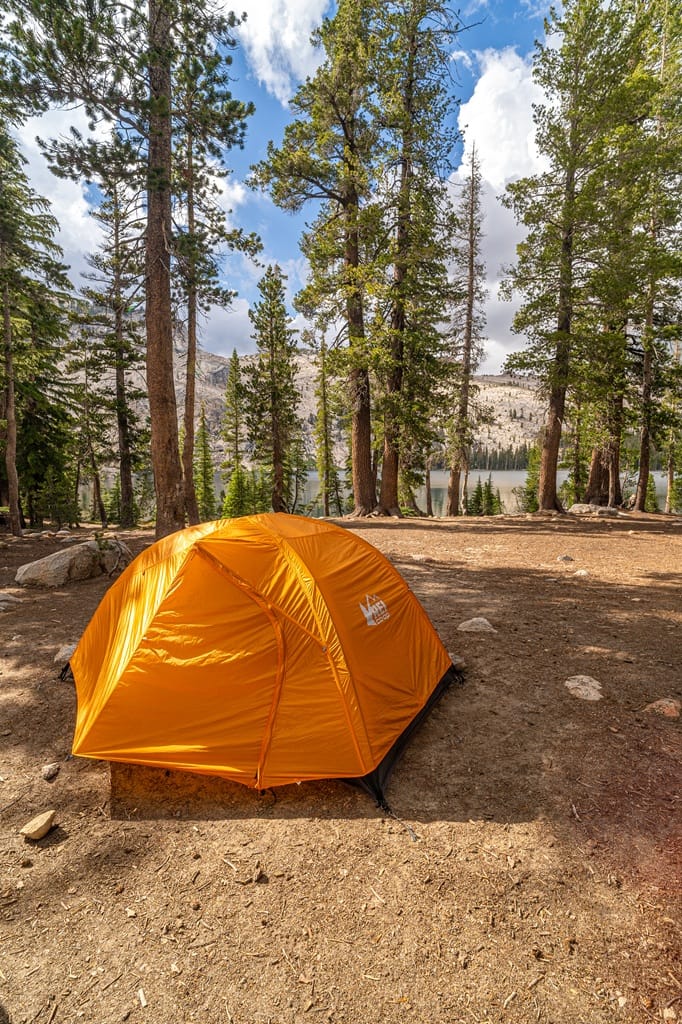 Campsite with an orange tent at May Lake in Yosemite National Park.